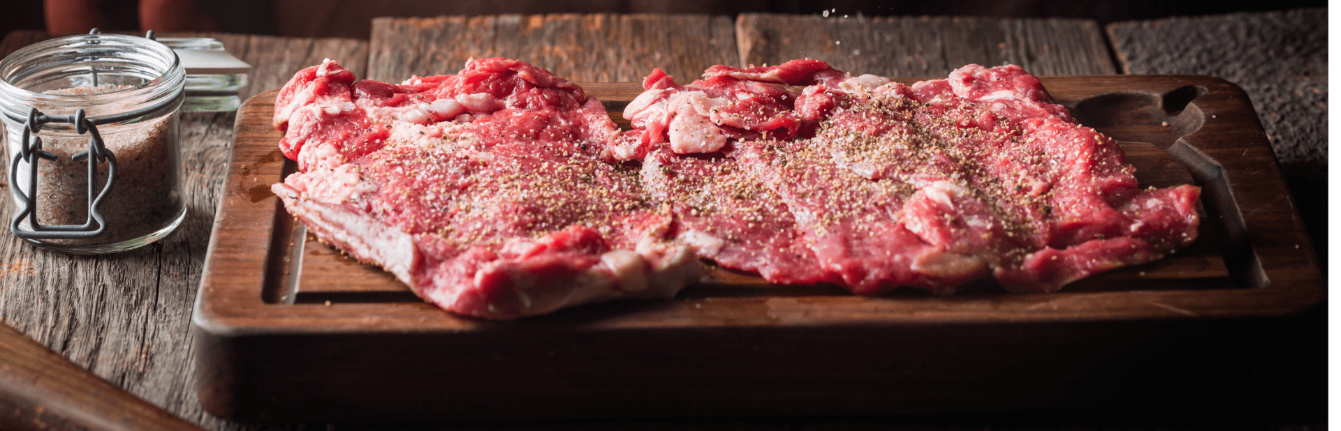 man cooking meat steaks