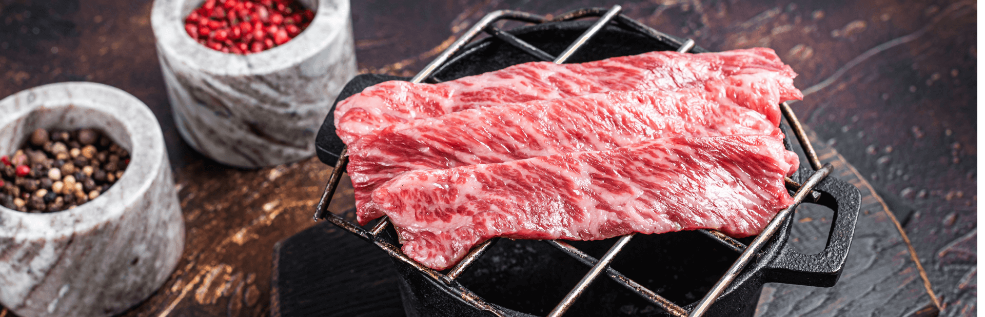 premium raw sliced wagyu beef a5 steaks on a grill